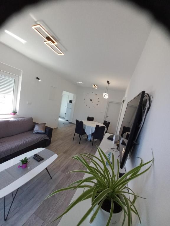 a living room with a couch and a table at Apartment Sunset in Trogir