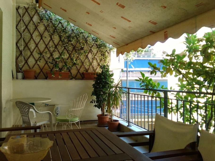 a patio with a table and chairs on a balcony at Filoxenia Panormou in Athens
