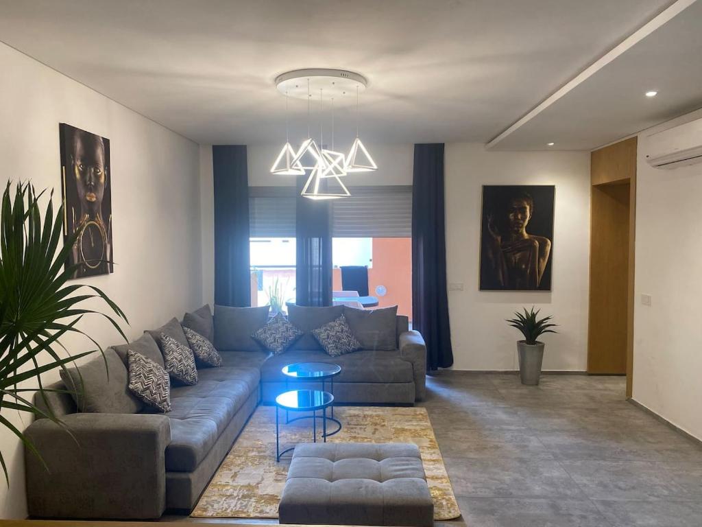 a living room with a couch and a table at Marrakchia apartment Guéliz in Marrakesh