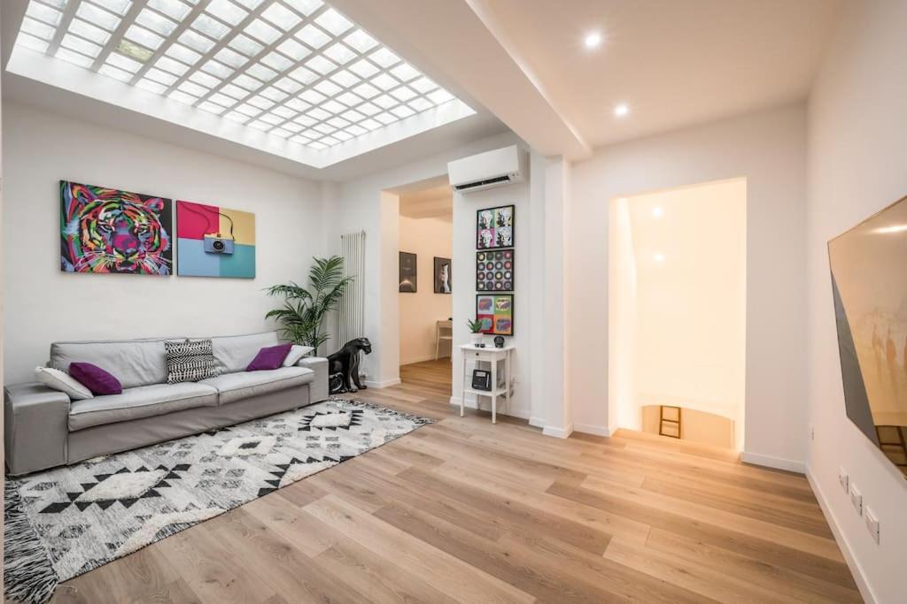 a living room with a couch and a rug at Santo Stefano Apartment with private Garden in Bologna