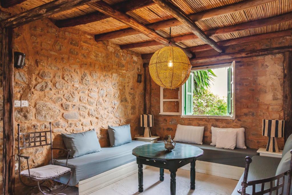 a living room with a couch and a table at Khanfous Retreat in Asilah