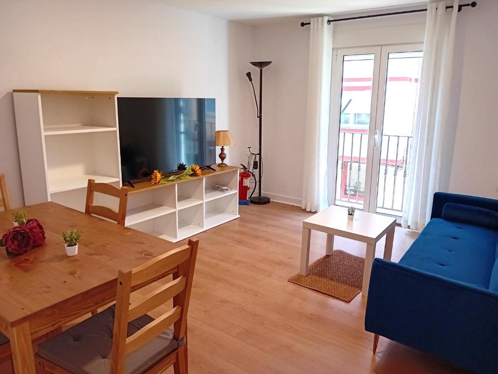 a living room with a television and a table at Santa Olalla en el norte in Santander