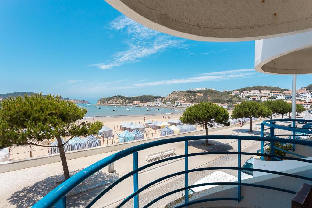 a balcony with a view of a beach at SUNSET1 - By Smarthomes in São Martinho do Porto
