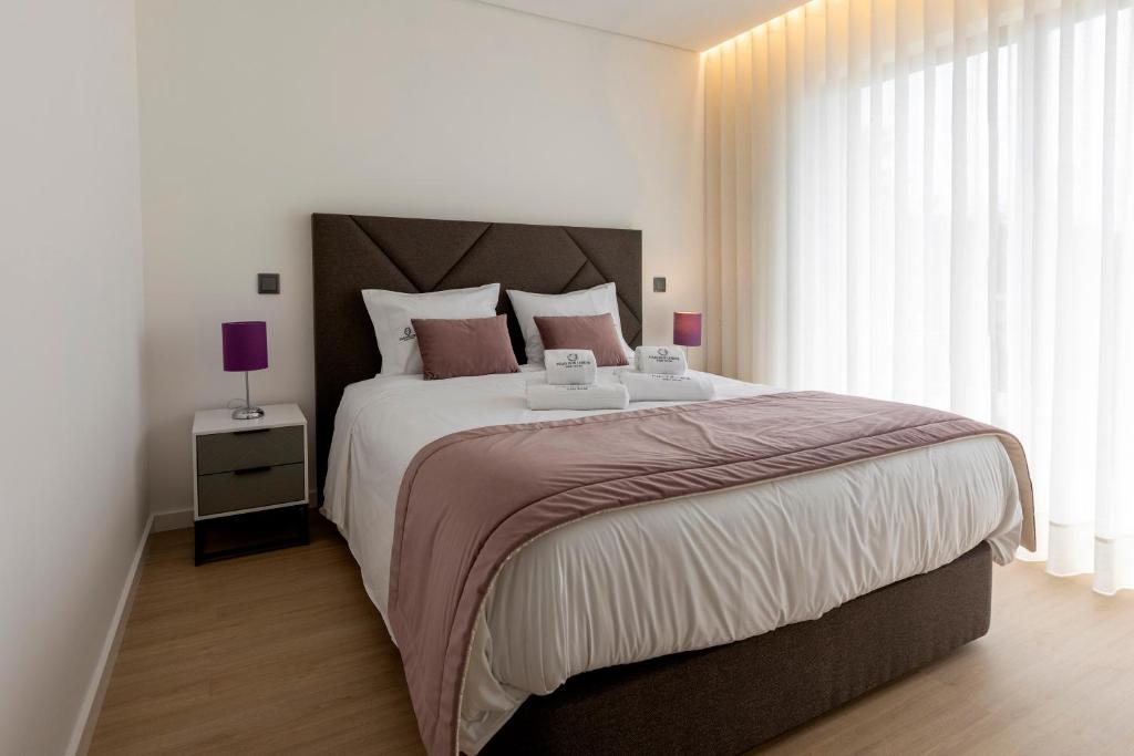 Postel nebo postele na pokoji v ubytování Guest House Fojo dos Lobos