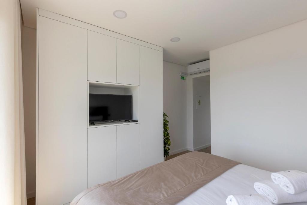 Postel nebo postele na pokoji v ubytování Guest House Fojo dos Lobos