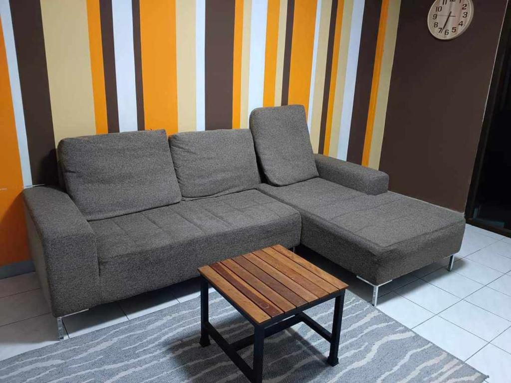 ein graues Sofa in einem Zimmer mit Couchtisch in der Unterkunft Cawleys house in Bang Phli
