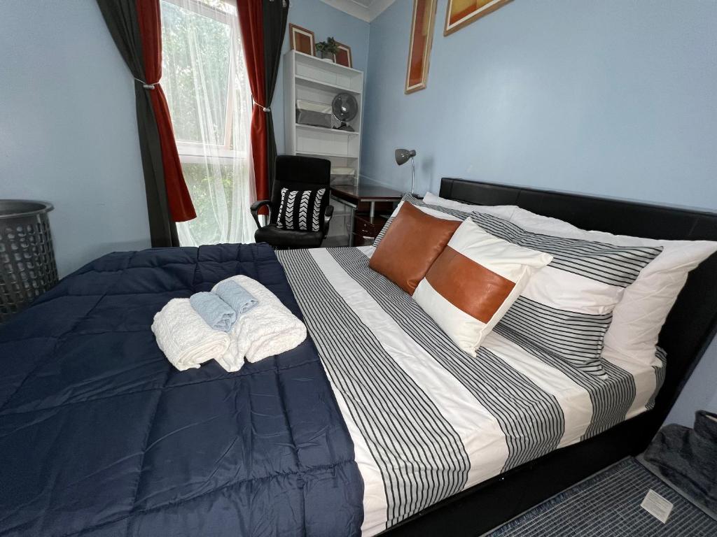 a bedroom with a bed with two towels on it at Quayside Deluxe Double Room in Colchester