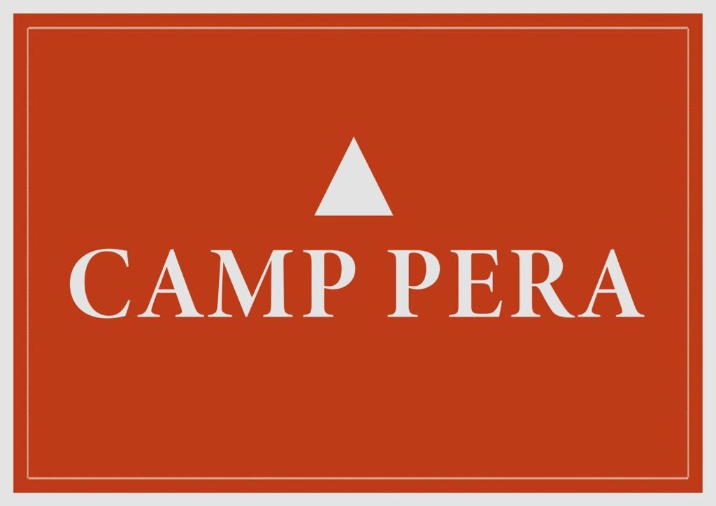 a camp perra text on an orange background at Camp Pera in Täsch