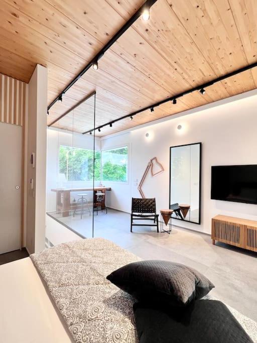 a bedroom with a large bed and a living room at ALC1 Ampio appartamento 4 persone in San Giovanni in Marignano
