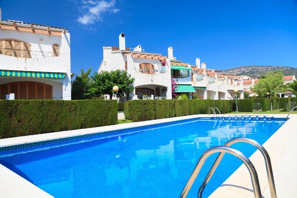 a swimming pool in front of some buildings at UHC Arenal Family Complex in Hospitalet de l'Infant