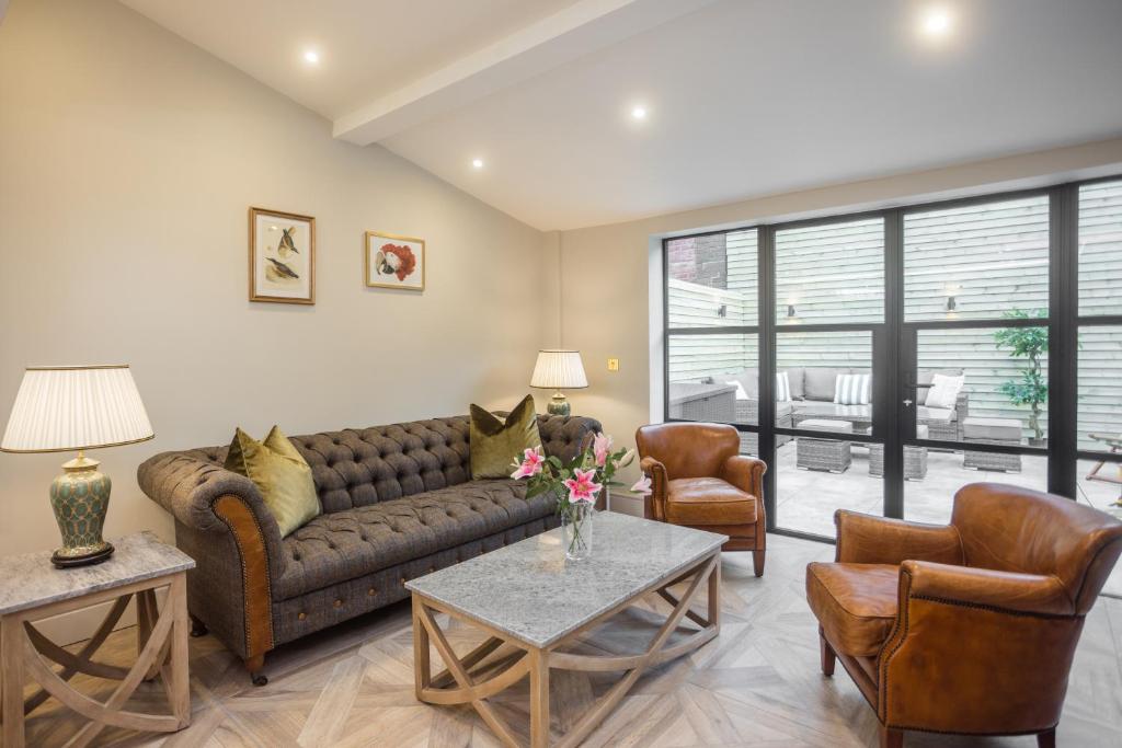 a living room with a couch and two chairs at Historic City Centre Town House in Chester