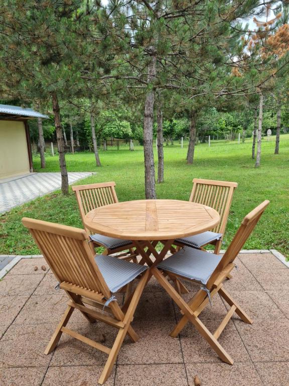 a wooden table and two chairs sitting next to each other at Kuća za odmor Čanić gaj in Gospić