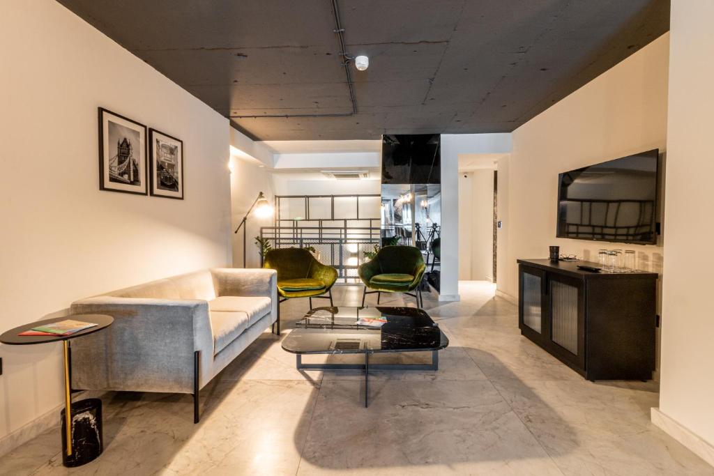a living room with a couch and a table at The Londoner Hotel Sliema in Sliema