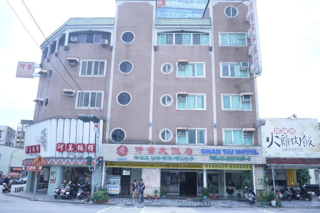 a tall building with round windows on a city street at Chantai Hotel in Hualien City