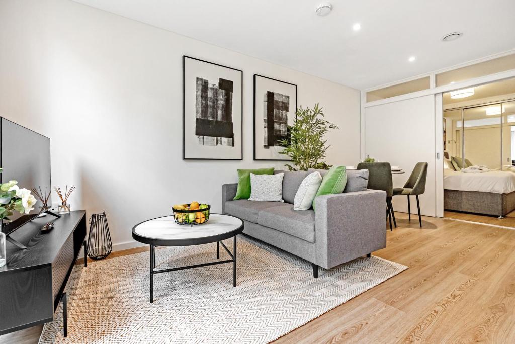 a living room with a couch and a table at Tailored Stays - Central Cambridge, River Walk Apartments in Cambridge