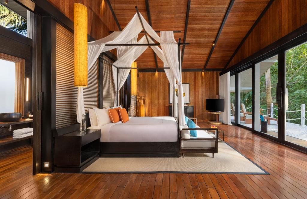 a bedroom with a bed with a canopy at Taj Exotica Resort & Spa, Andamans in Havelock Island