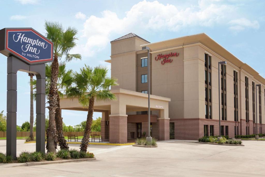 a rendering of a hotel with a sign and palm trees at Hampton Inn Houston Hobby Airport in Houston