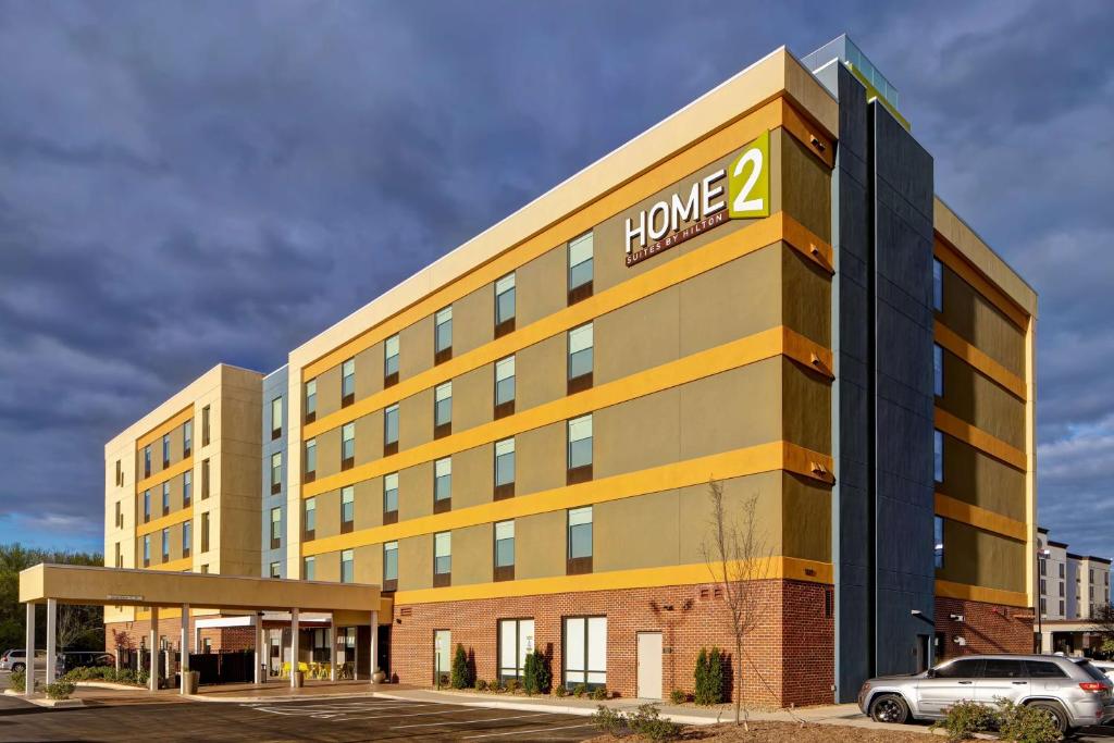 a large building with the words home at Home2 Suites By Hilton Charlotte Northlake in Charlotte