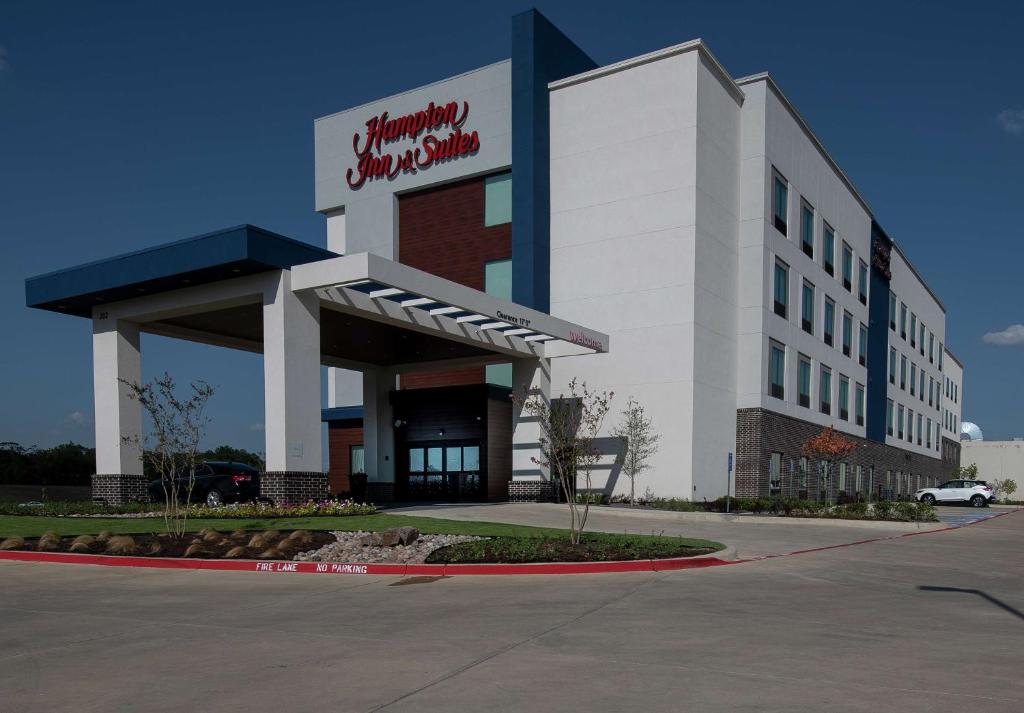 a building with a sign on the side of it at Hampton Inn & Suites Duncanville Dallas, Tx in Duncanville