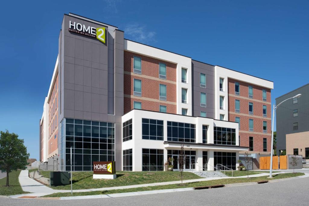 a hotel building with a sign on the front of it at Home2 Suites By Hilton Omaha Un Medical Ctr Area in Omaha