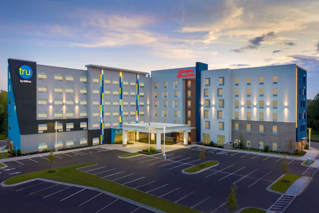 a hotel with a parking lot in front of it at Tru By Hilton Charlotte Airport Lake Pointe in Charlotte