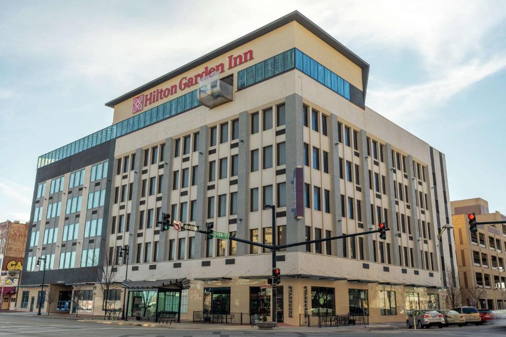 a large building with a sign on top of it at Hilton Garden Inn Wichita Downtown, Ks in Wichita