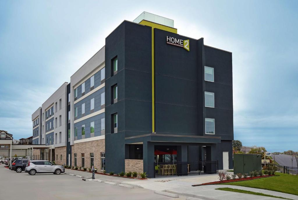 a large black building with a house sign on it at Home2 Suites by Hilton Liberty NE Kansas City, MO in Liberty