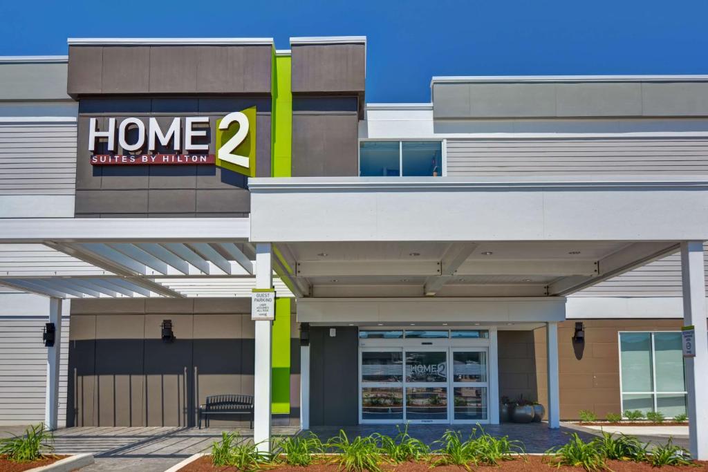 a home building with a sign on it at Home2 Suites Williston Burlington, Vt in Williston