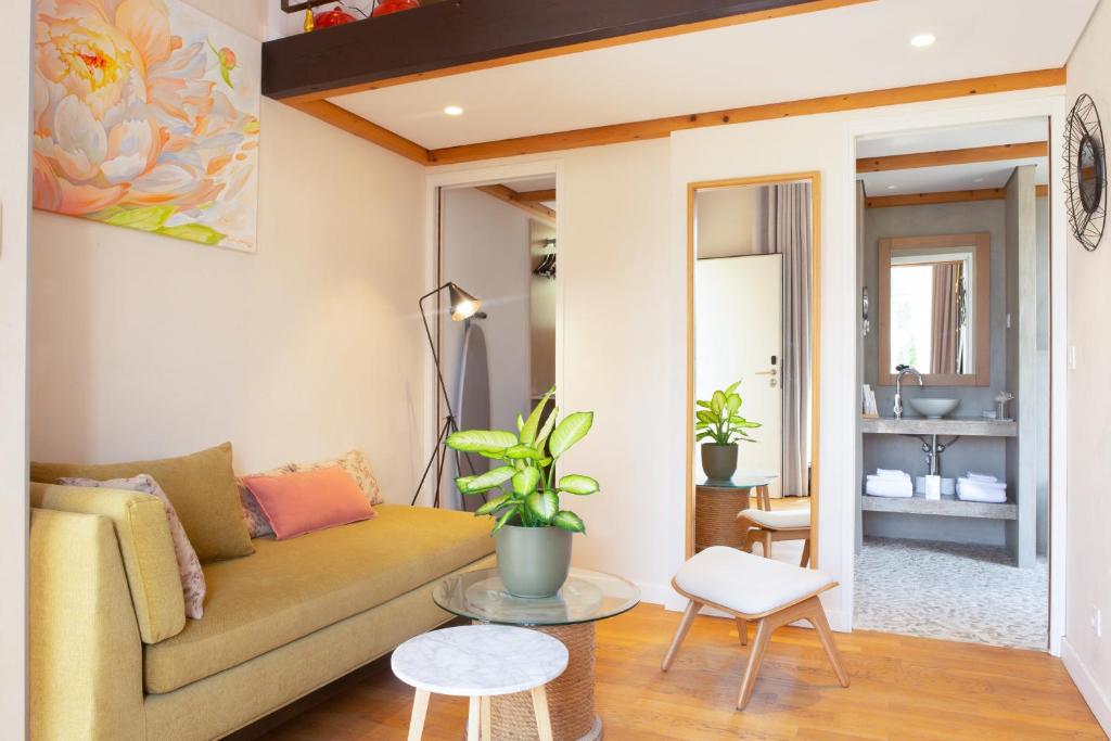 a living room with a couch and a table at Boutique Hôtel Villa Fabulite in Antibes