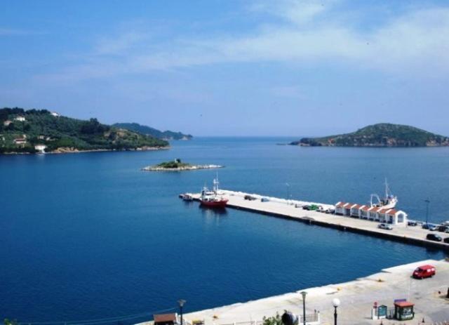a large body of water with a dock in it at Vetti Rooms in Skiathos