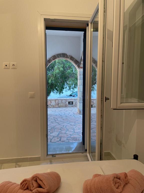 a room with a window looking out onto a courtyard at Diakofti house by the sea - Kythoikies hoilday houses in Kythira