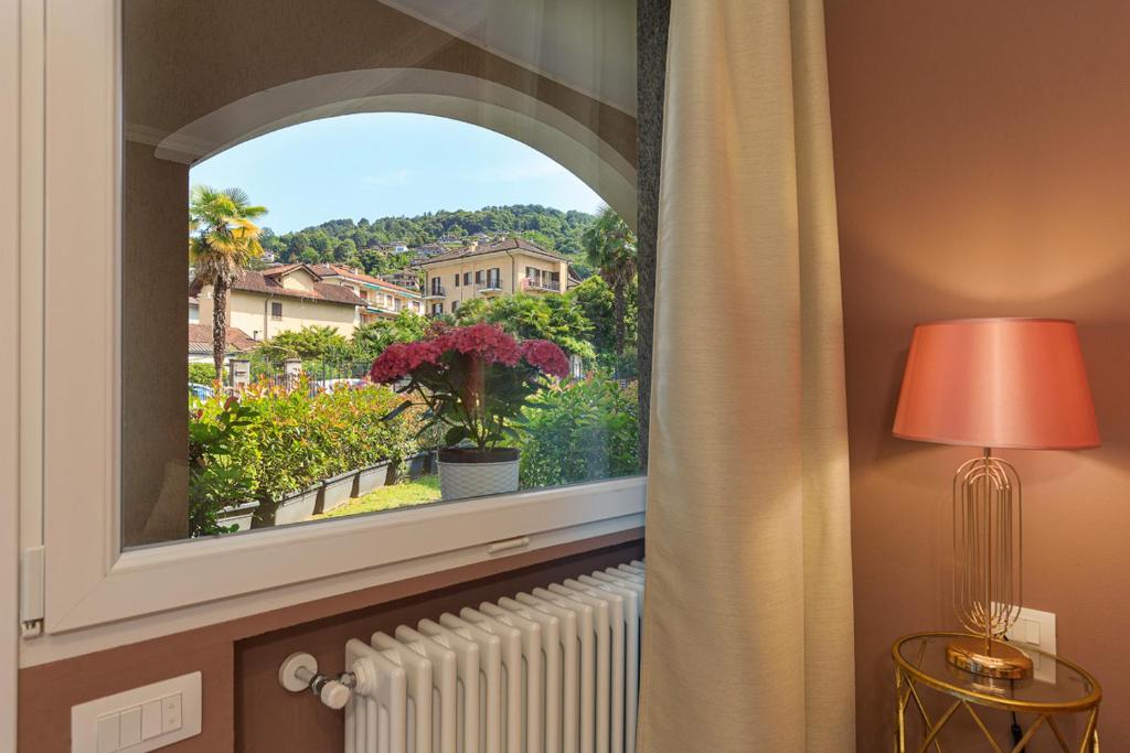 an arched window in a room with a radiator at Emerald Suites in Stresa