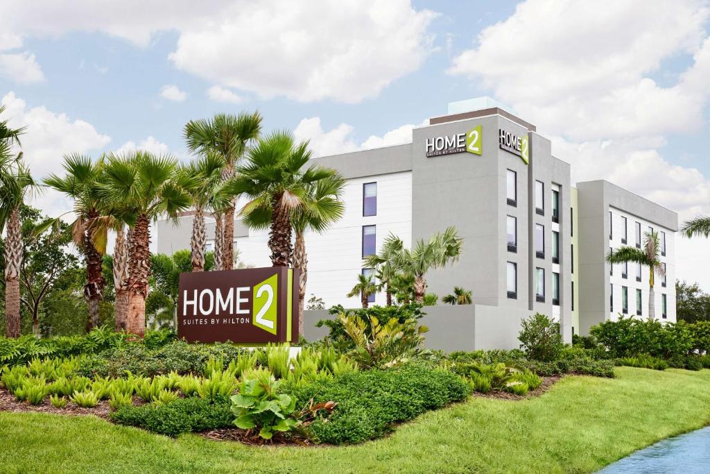 a hotel with a sign in front of a building at Home2 Suites By Hilton Stuart in Stuart