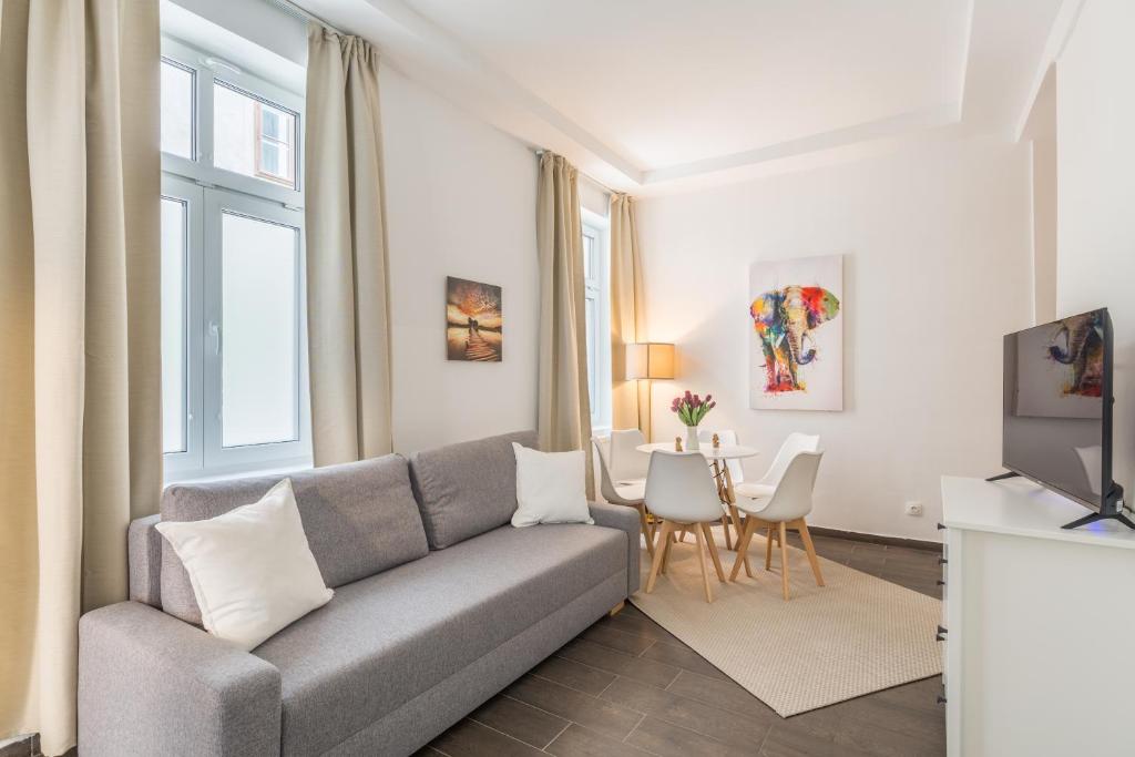 a living room with a couch and a table at Cozy Heaven in the lovely 2nd district of Vienna in Vienna