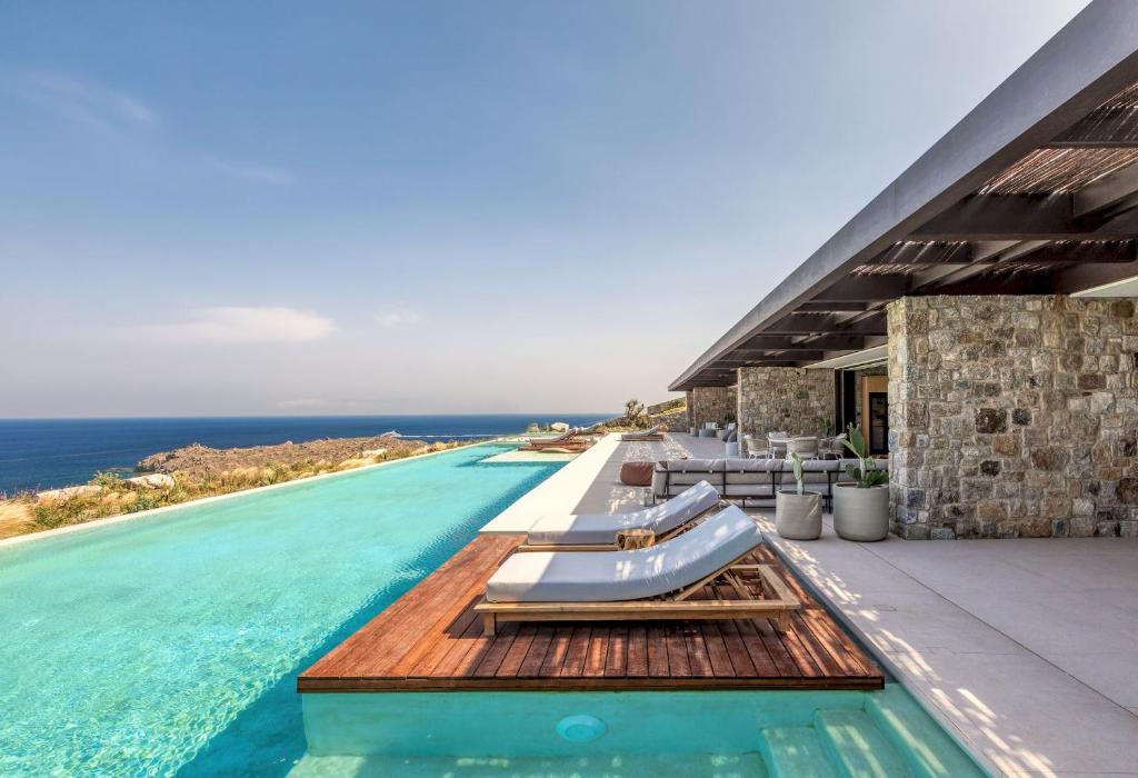 a swimming pool with a view of the ocean at Untold Mykonos in Mikonos