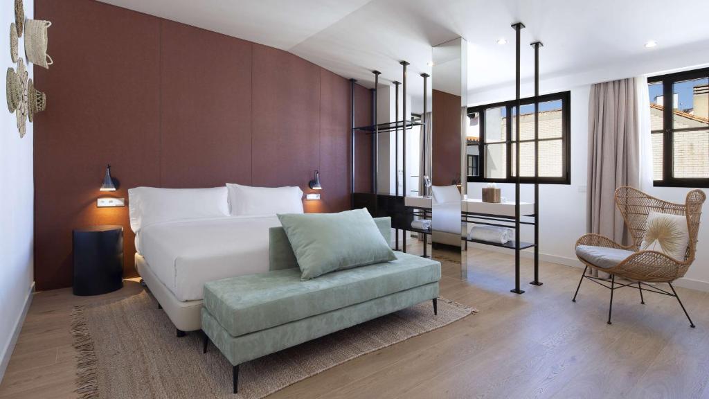 sypialnia z łóżkiem, krzesłem i biurkiem w obiekcie Atocha Hotel Madrid, Tapestry Collection by Hilton w Madrycie