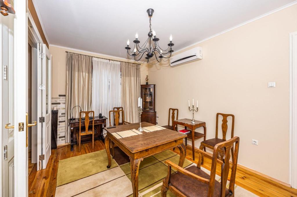 a dining room with a table and chairs at Rectorate Apartment in Plovdiv