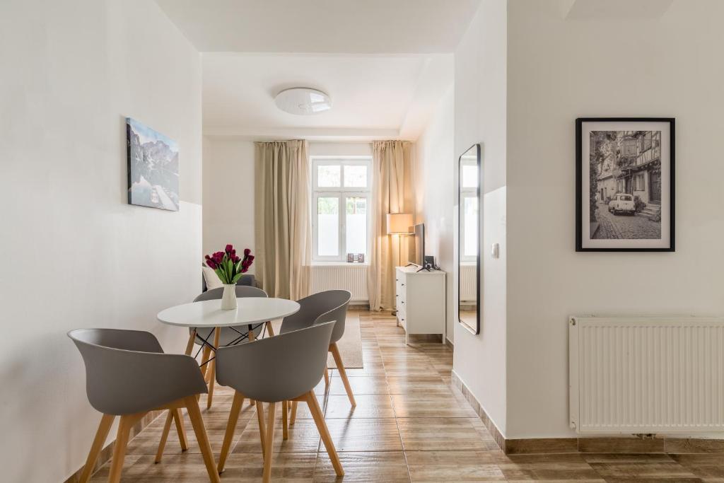 a dining room with a table and chairs at XXXl bed/ free parking/ central in Vienna