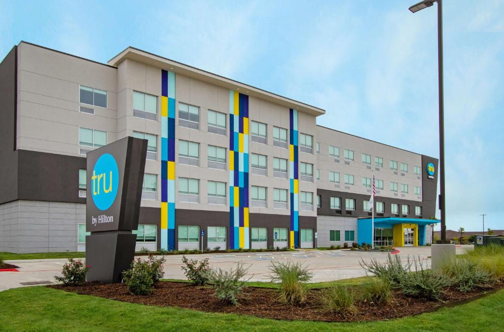 a building with a sign in front of it at Tru By Hilton Waco South in Waco