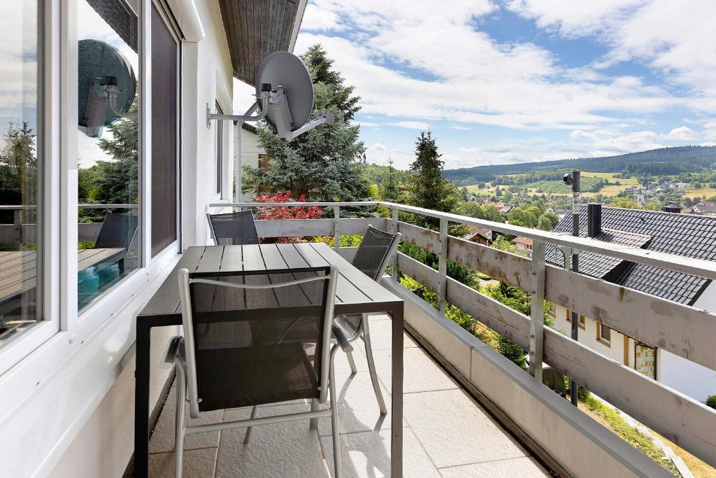 a balcony with a table and chairs and a view at Sonnenblick in Lenzkirch