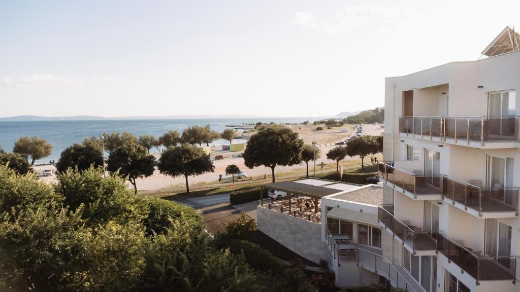 an apartment building with a view of the beach at Hotel Fanat in Split