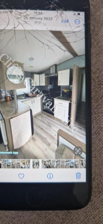 a cell phone screen showing a room with a table at Cliffs caravan hire in Gisburn