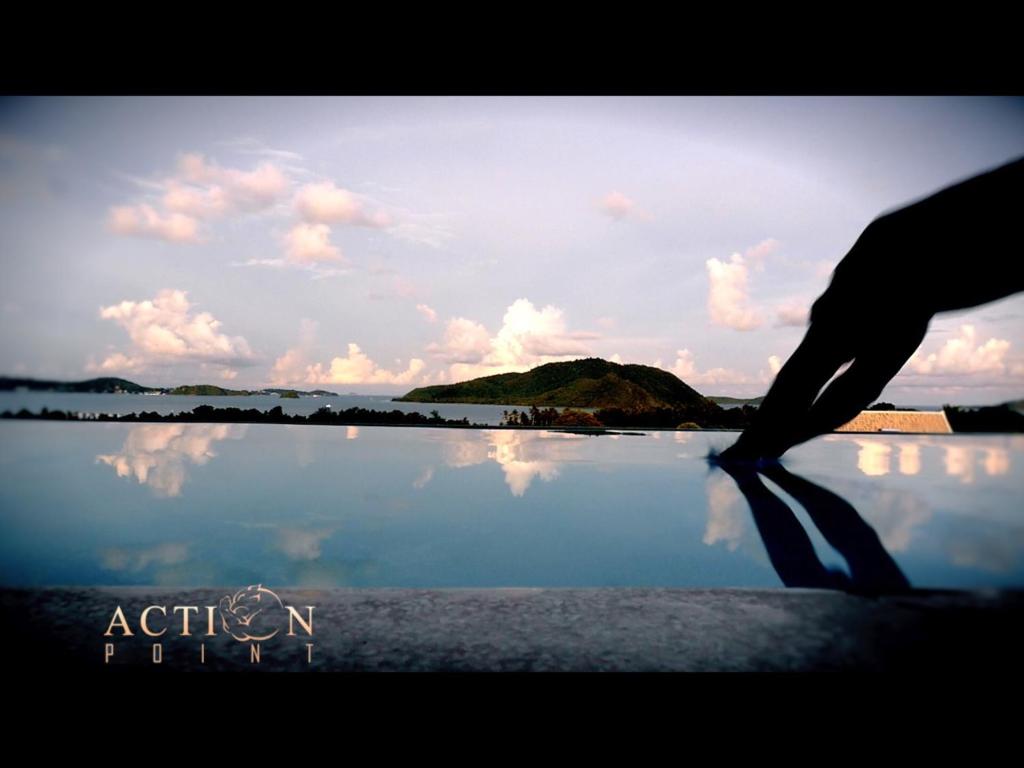 a person standing in front of a body of water at Action Point Weight loss and Fitness Resort in Rawai Beach