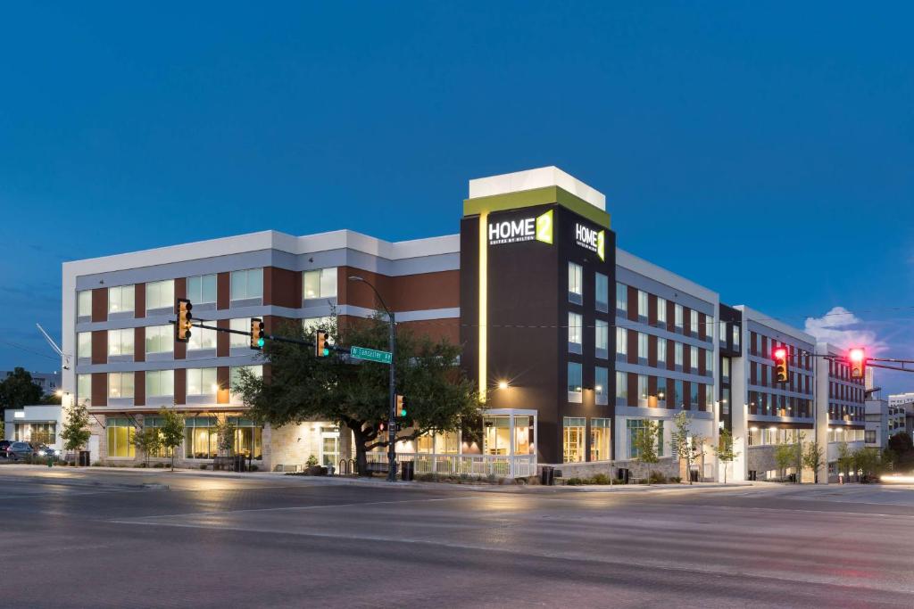 a large building on a street corner at night at Home2 Suites by Hilton Fort Worth Cultural District in Fort Worth