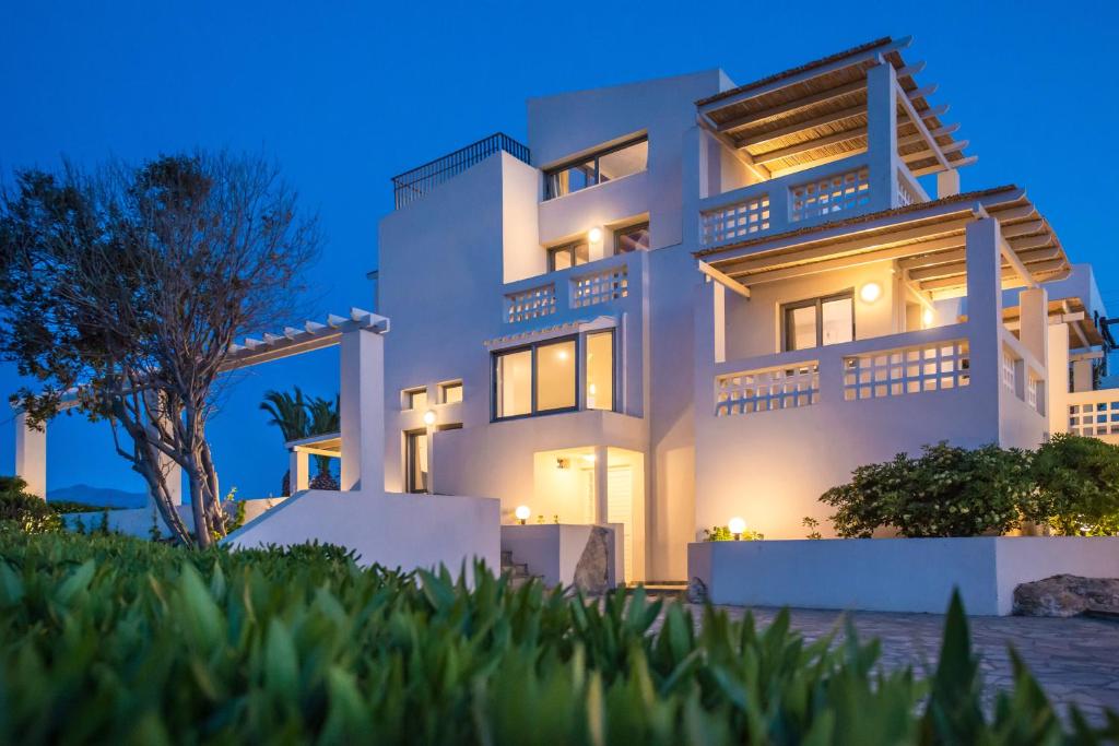 a large white house at night at Almyra Seaside Houses in Hersonissos