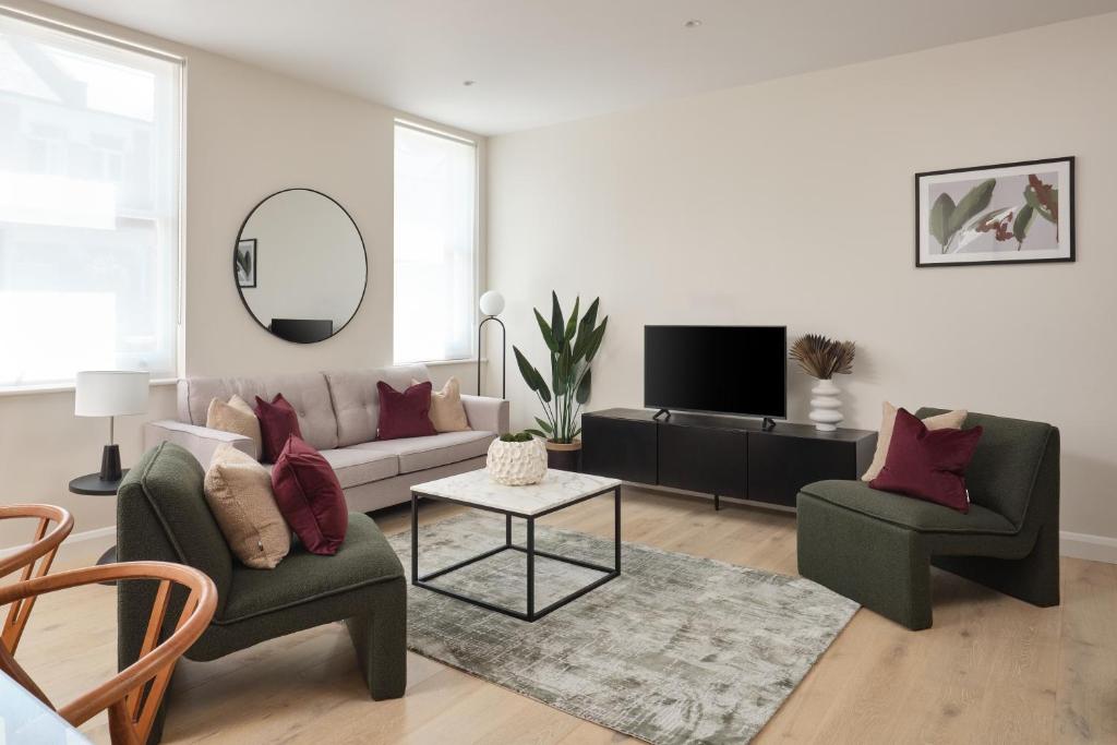 a living room with a couch and two chairs at Fulham - Hestercombe House by Viridian Apartments in London