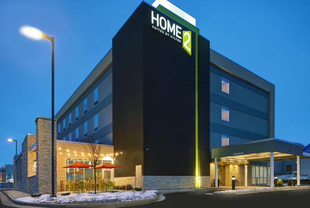 a building with a sign on the side of it at Home2 Suites By Hilton Richmond in Richmond