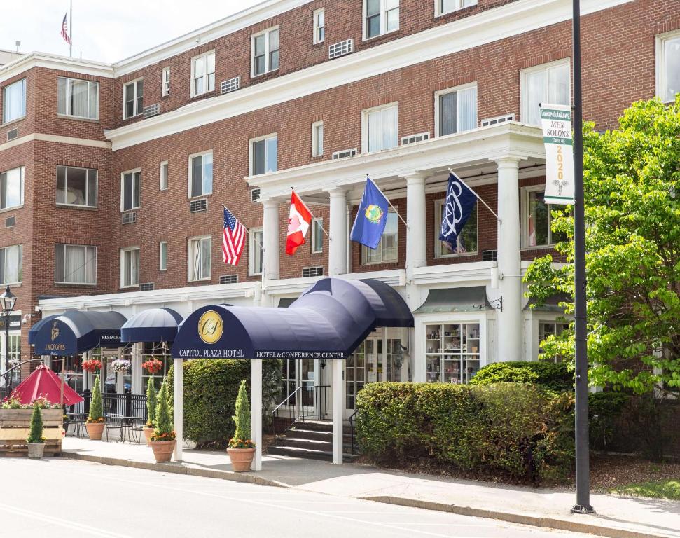 a hotel with flags in front of a building at Capitol Plaza Hotel Montpelier Tapestry Collection by Hilton in Montpelier