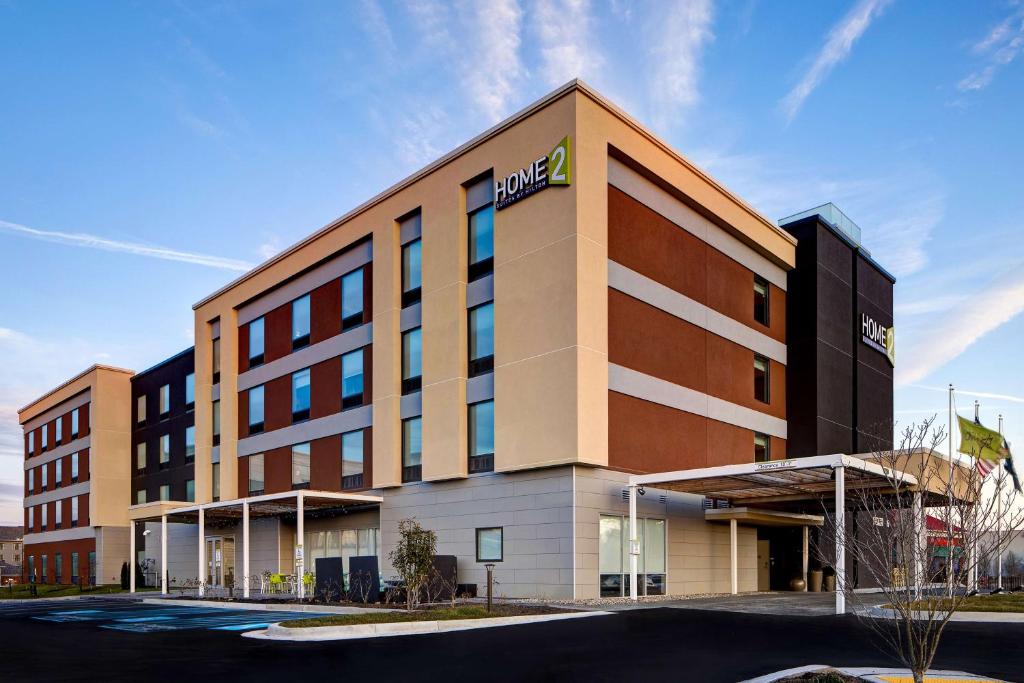a hotel building with a sign on the front of it at Home2 Suites By Hilton Lexington Hamburg in Lexington