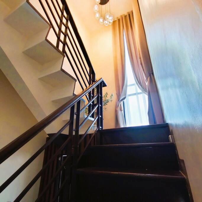 a stairway with a window and a stair case at Stellar Homesharing 1 in Davao City